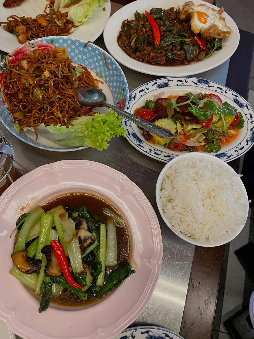 Clockwise from top right: pad krapow, pickled mustard greens and Chinese sausage, steamed vegetables in soy bean sauce, and chicken noodles in red roast pork sauce (Hannah Twiggs)
