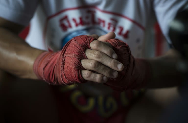 World Boxing Council minimum weight champion Wanheng Menayothin clasps his wrapped knuckles during an interview with AFP before training in Bangkok. Nicknamed the "dwarf giant", with one more win he will equal Floyd Mayweather's undefeated 50-fight record