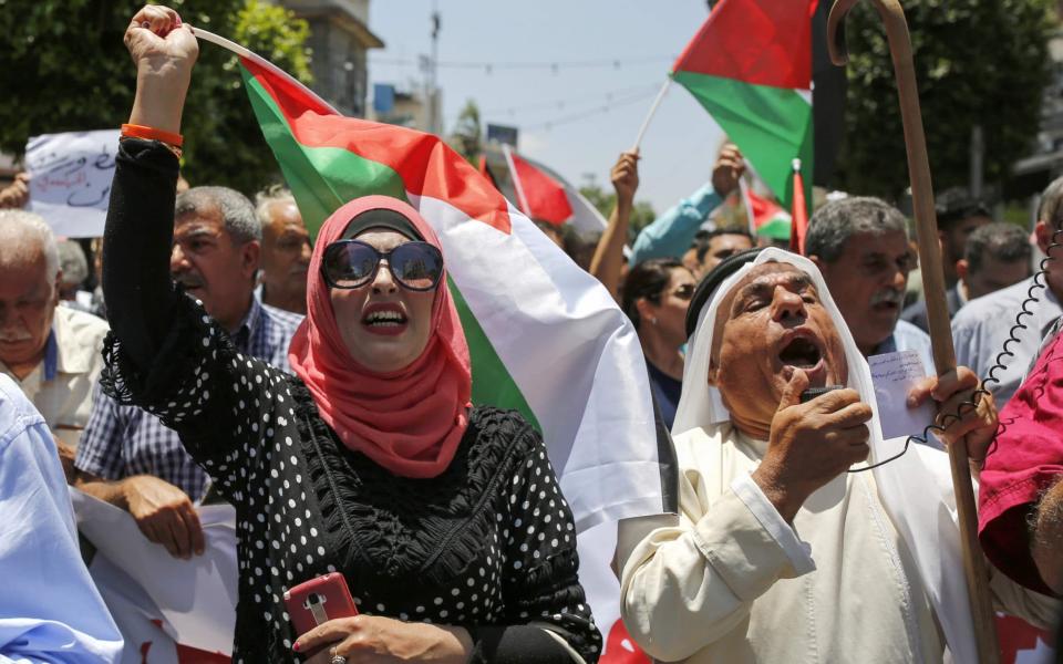 Palestinians in the occupied West Bank town of Ramallah protest against the US peace plan - AFP
