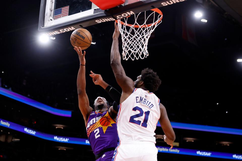 Phoenix Suns forward Josh Okogie (2) attempts a shot over Philadelphia 76ers center Joel Embiid (21) during the first half at Footprint Center in Phoenix on March 25, 2023.