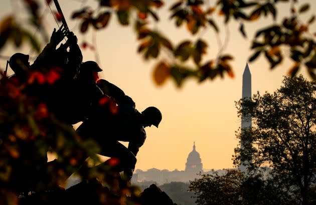 The U.S. Marine Corps' Iwo Jima Memorial can be seen as the morning sun begins to rise behind the U.S. Capitol and Washington Monument on Nov. 7, 2020, in Arlington, Virginia. (Photo: Al Drago via Getty Images)