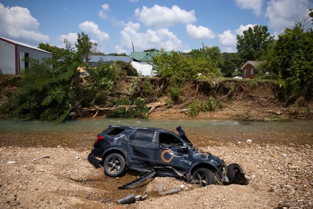 A vehicle destroyed by flooding sits in Trace Creek in Waverly, Tennessee. Heavy rains on Sunday caused flash flooding in the area, killing at least 22 people. (Photo: Brett Carlsen via Getty Images)