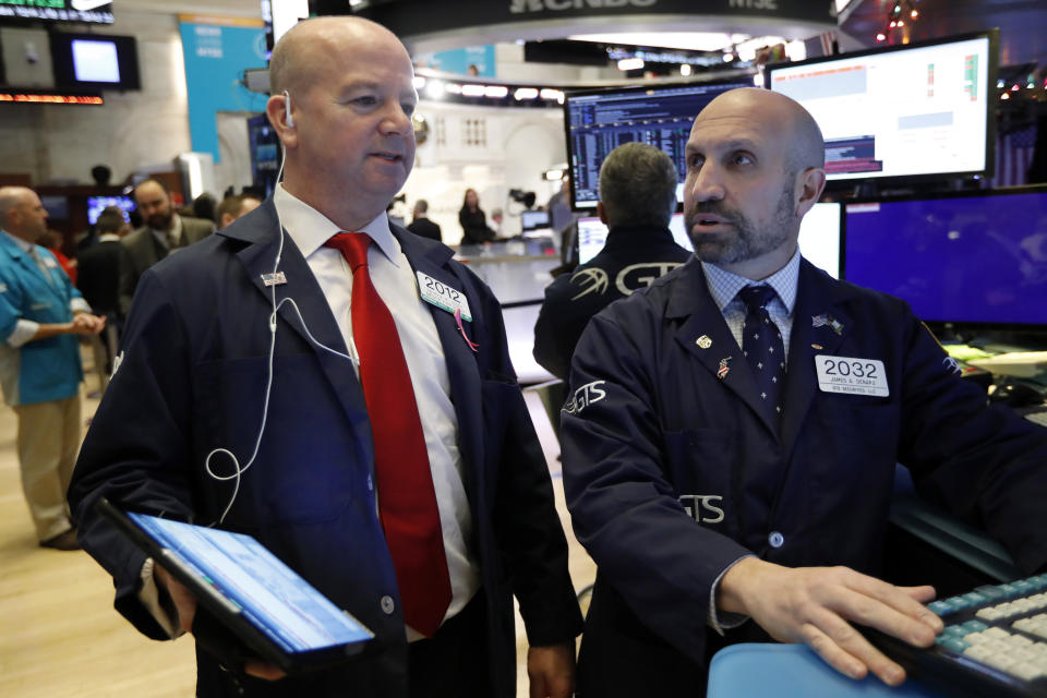 Trader Patrick Casey, left, and specialist James Denaro work on the floor of the New York Stock Exchange, Wednesday, Dec. 11, 2019. Stocks are opening mixed on Wall Street following news reports that US President Donald Trump might delay a tariff hike on Chinese goods set to go into effect this weekend. (AP Photo/Richard Drew)