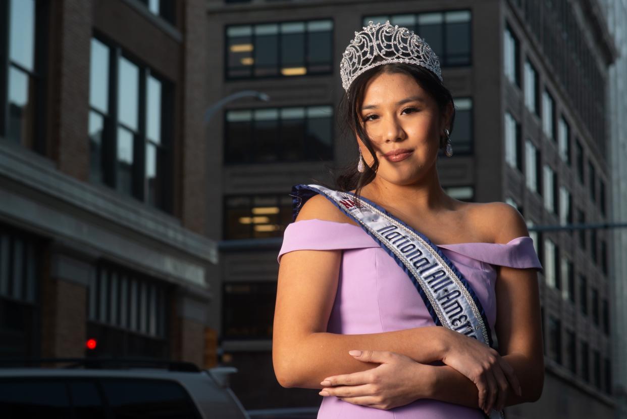 Seaman's Madison Wabaunsee proudly stands downtown Friday afternoon wearing her tiara and sash from the National All-American Miss Jr. Teen competition she claimed last month.