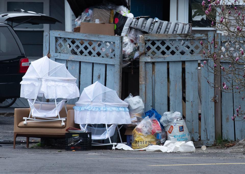 Bassinets were among items left near a full dumpster on Wednesday at Harborside Suites in South Yarmouth. State sheltered families living at the hotel were being moved to off-Cape agencies that provide improved services, a state spokesman said.