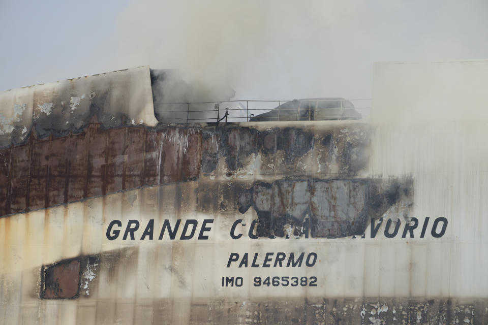 FILE Emergency personnel battle against a fire aboard the Italian-flagged Grande Costa d'Avorio cargo ship at the Port of Newark, Friday, July 7, 2023, in Newark, N.J. On Wednesday, Jan. 10, 2024, the U.S. Coast Guard and the National Transportation Safety Board began a series of investigative hearings into the cause of the fire, and plan to issue recommendations to avoid similar incidents in the future.(AP Photo/John Minchillo)