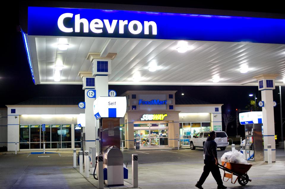 A night worker hauls garbage at Dixon Landing Chevron in Milpitas, Calif., on Thursday, Feb. 20, 2014. According to California lottery officials, the store sold the lone winning ticket for a $425 million Powerball jackpot but there was no immediate word on who may have won one of the largest lottery jackpots in U.S. history. (AP Photo/Noah Berger)