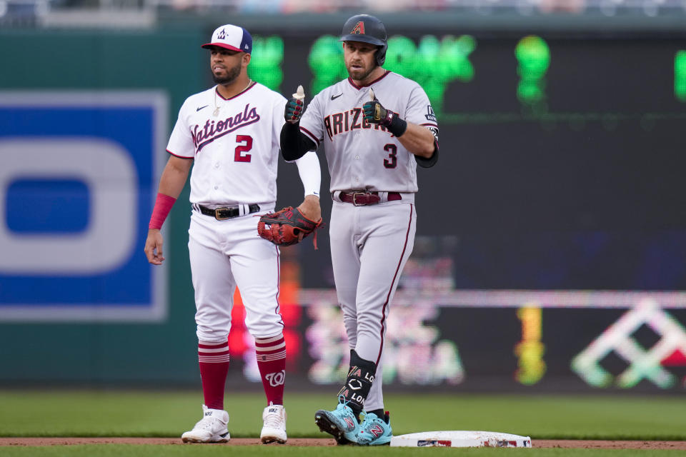 Arizona Diamondbacks designated hitter Evan Longoria (3) celebrates his RBI double, as Washington Nationals second baseman Luis Garcia (2) stands nearby during the first inning of a baseball game at Nationals Park, Wednesday, June 7, 2023, in Washington. (AP Photo/Alex Brandon)