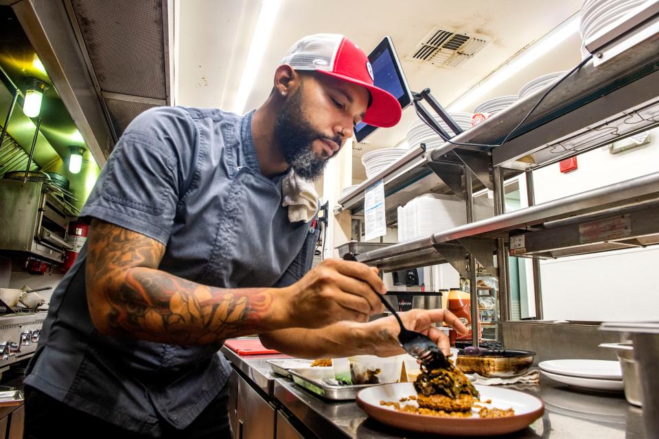 Chef Ed Lordman of The Pointe in Gulf Breeze plates his boudin cake, greens and red fish dish Saturday, Aug. 27, 2022. The chef was recently hired to craft the breakfast, lunch, dinner and banquet menus.