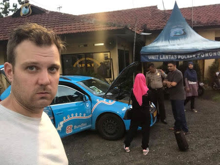 Dutch adventurer Wiebe Wakker on his electric car journey from the Netherlands to Australia, in Porong, Indonesia December 2017 in this picture obtained from social media. Picture taken December 2017. WIEBE WAKKER/PLUG ME IN PROJECT/via REUTERS