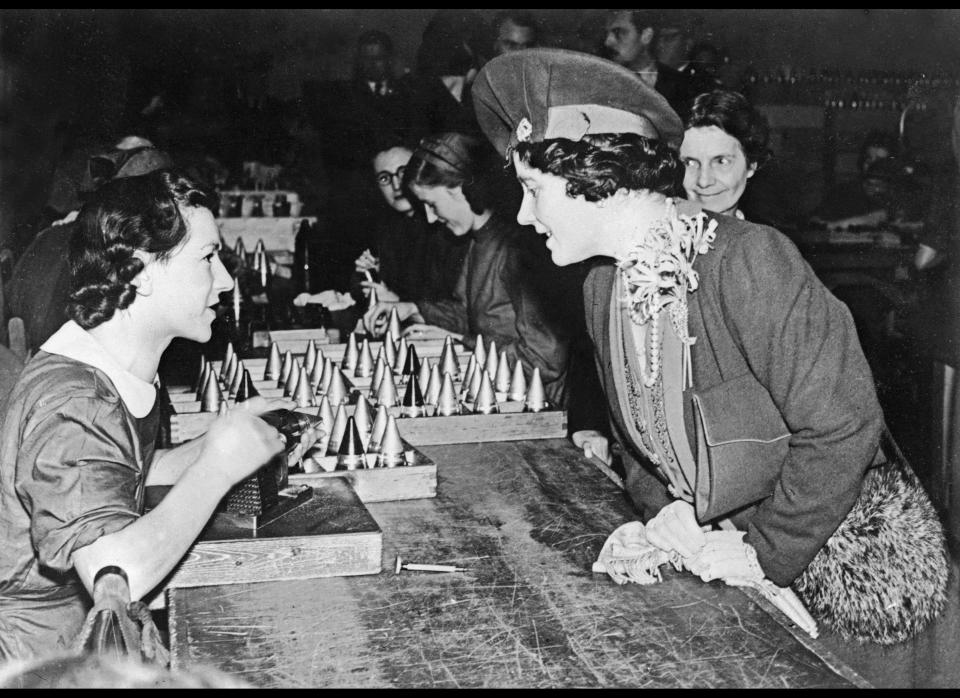 <p>Queen Elizabeth chats with a girl on April 18, 1940 during&nbsp;visit to an ammunition factory somewhere in Midlands.</p>