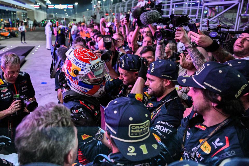 Max Verstappen, left, celebrates winning his third championship with his team after the sprint race ahead of the Qatari Formula One Grand Prix at the Lusail International Circuit on Oct. 7, 2023.