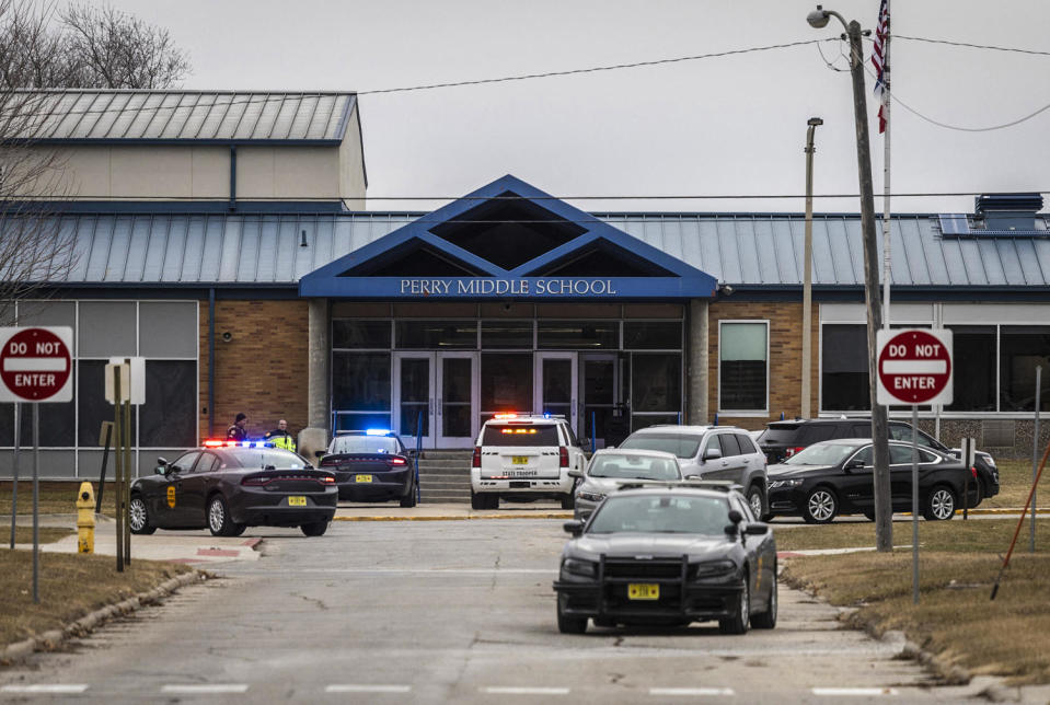 Image: Police officers secure the campus at Perry Middle and High School (Christian Monterrosa / AFP - Getty Images)