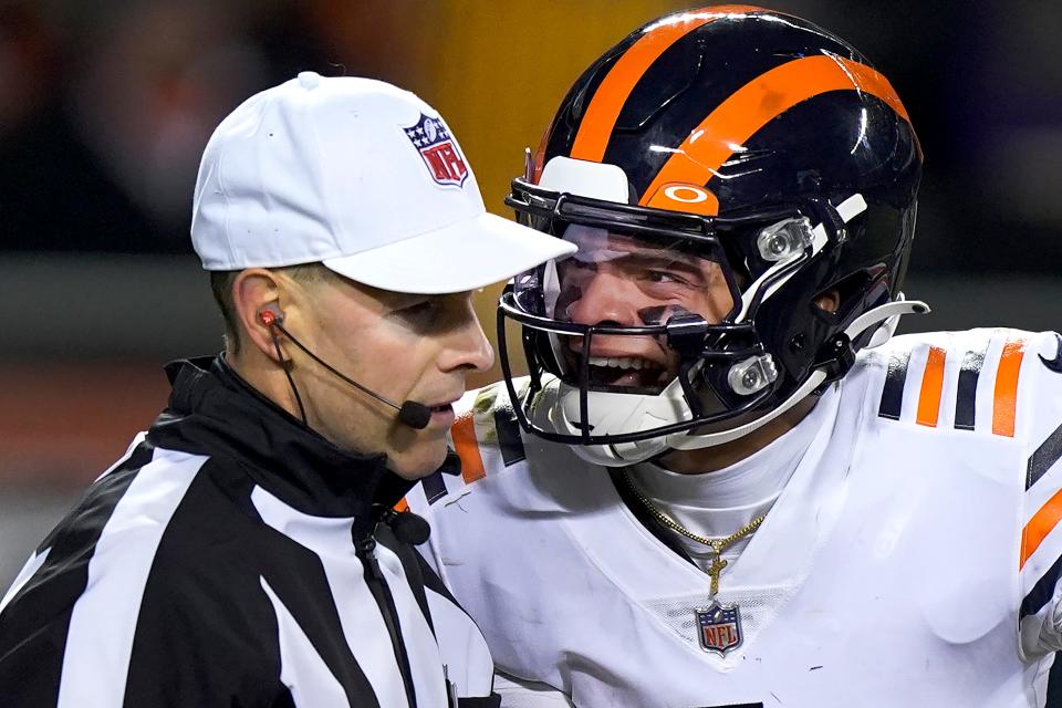 Chicago Bears quarterback Justin Fields, right, yells at referee Scott Novak after Fields was tackled hard into the ground by Minnesota Vikings defensive tackle James Lynch during a game on Dec. 20, 2021.