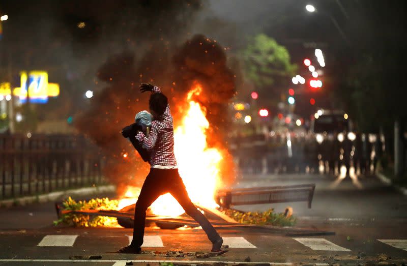 Demonstrator gestures during a protest against racism, after Joao Alberto Silveira Freitas was beaten to death by security guards at a Carrefour supermarket in Porto Alegre