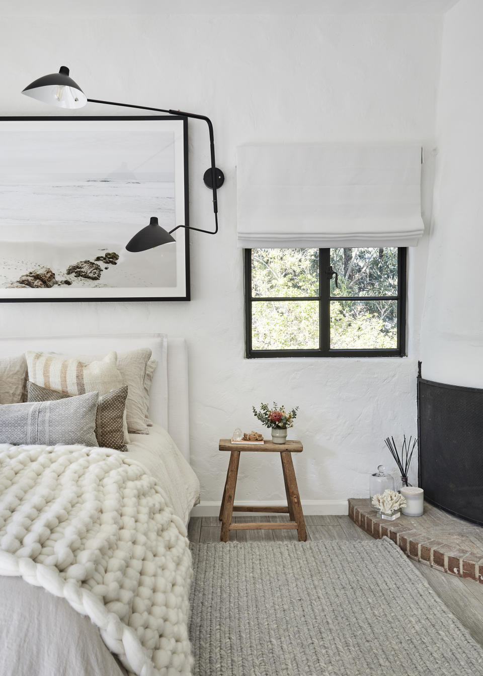 <p> Neutral shades are enduringly popular bedroom colors, helping to create calming, comforting spaces conducive for sleep. Opting for warmer, earthy shades like stone and clay will bring a comforting and grounding feel.  </p> <p> In this white bedroom Julia Dempster has layered chunky texture to bring a warm and cozy feel to the space. ‘I love using linen bedlinen against vintage pillows with a thick woven wool throw to dress the bed, a thick pile knotted rug adds to the contrasting texture against the rustic reclaimed wood stool which doubles as a bedside table,’ says the interior designer. </p>