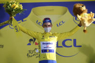 France's Julian Alaphilippe, wearing the overall leader's yellow jersey celebrates on podium after winning the second stage of the Tour de France cycling race over 186 kilometers (115,6 miles) with start and finish in Nice, southern France, Sunday, Aug. 30, 2020. (Stuart Franklin/Pool photo via AP)