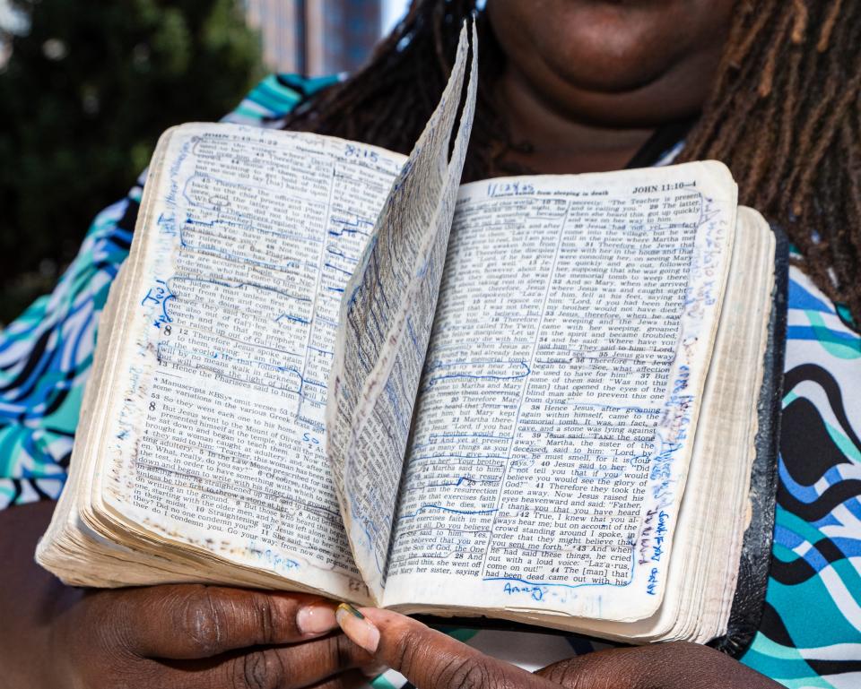 Angelique Sharpe, sister of Samuel Sharpe Jr., holds her brother’s Bible after a rally at Red Arrow Park on Thursday in Milwaukee. Sharpe was shot and killed Tuesday by out-of-state officers who saw him confronting a man with knives in each hand.