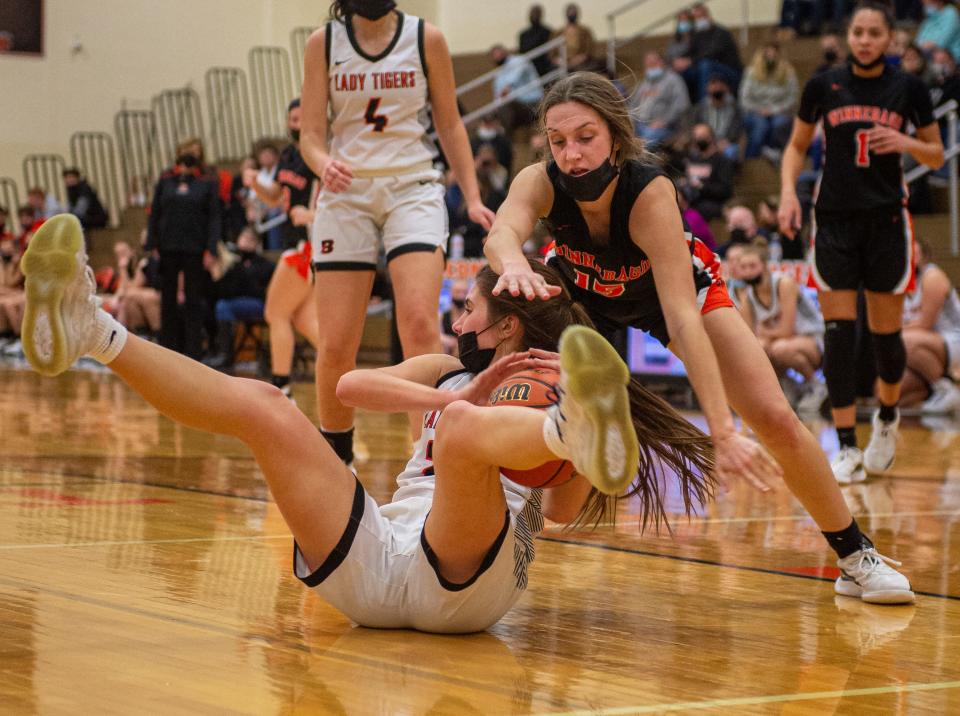 Winnebago's Campbell Schrank, right, and Byron's Ava Kultgren scramble for a rebound during the fourth quarter of their game on Wednesday, Jan. 19, 2022, in Byron.