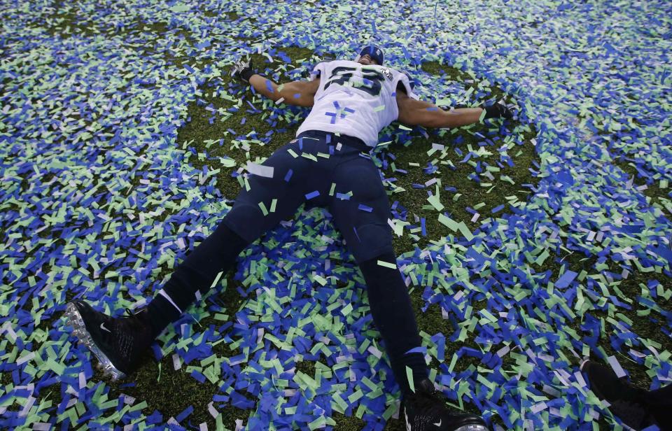 Seattle Seahawks Malcom Smith makes an angel in the confetti after his team defeated the Denver Broncos in the NFL Super Bowl XLVIII football game in East Rutherford, New Jersey, in this February 2, 2014 file photo. REUTERS/Shannon Stapleton/Files (UNITED STATES - Tags: TPX IMAGES OF THE DAY SPORT FOOTBALL)