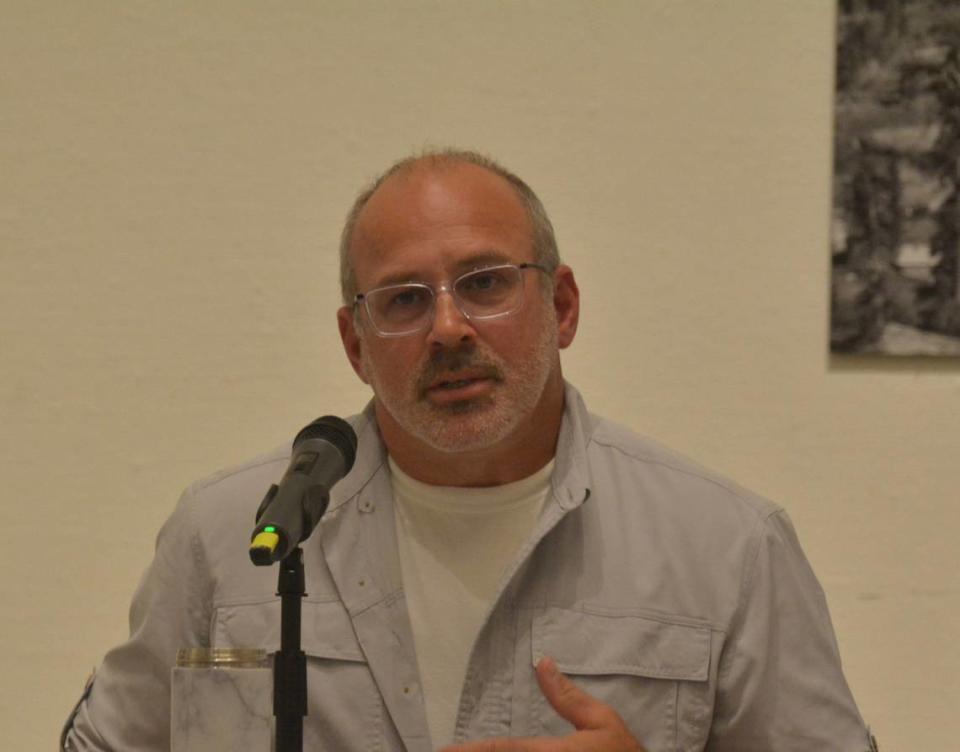 Mike McAuley talks with other candidates for mayor at a forum hosted by the Bellingham Chamber of Commerce and the Downtown Bellingham Partnership at the Whatcom Museum’s Old City Hall galleries on Tuesday.