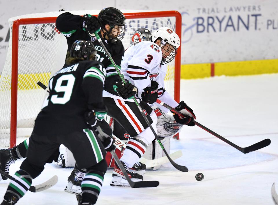 Connor Ford of North Dakota and St. Cloud State's Seamus Donohue battle for control of the puck in front of the SCSU goal during the first period of the game Saturday, Dec. 4, 2021, at the Herb Brooks National Hockey Center in St. Cloud.