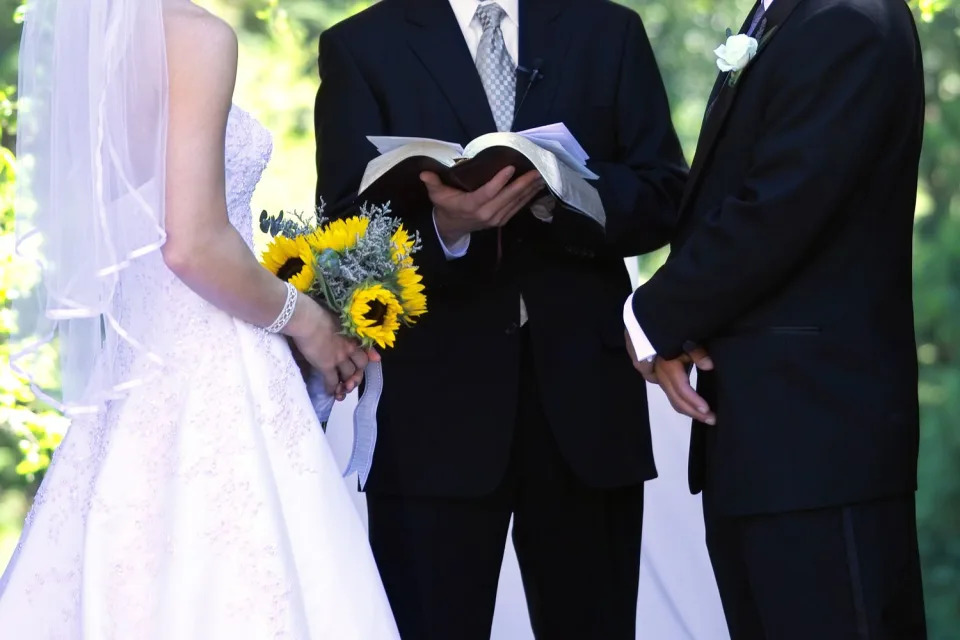 <p>Getty</p> Photo of a bride and groom during a wedding ceremony