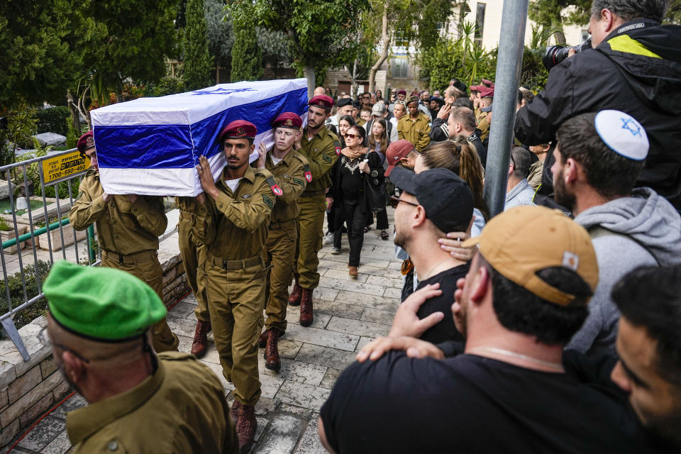 Israeli soldiers carry the casket Israeli solider Staff sergeant David Sasson as mourners gather in grief during his the funeral in Netanya, Israel, Thursday, March 7, 2024. Sasson, 21, was killed during Israel's ground operation in the Gaza Strip, where the Israeli army has been battling Palestinian militants in the war ignited by Hamas' Oct. 7 attack into Israel. (AP Photo/Ariel Schalit)