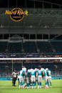 The Miami Dolphins huddle beneath the Hard Rock Stadium sign prior to the snap during an NFL preseason game against the Jacksonville Jaguars, Thursday, Aug. 22, 2019, in Miami Gardens, Fla. (Margaret Bowles via AP)