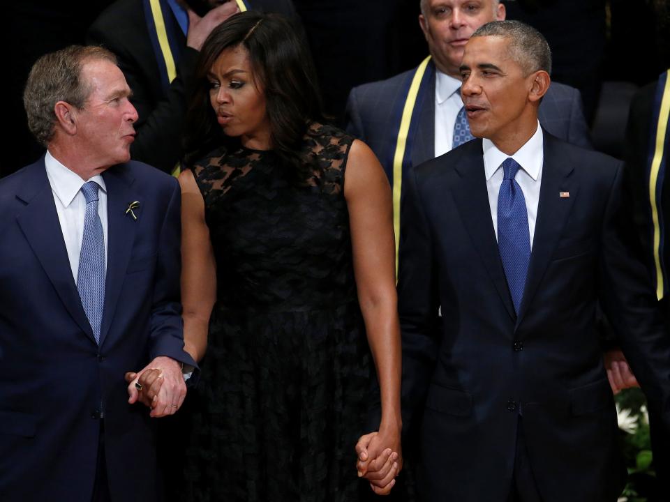 Former president George W. Bush (L) First Lady Michelle Obama (C) and U.S. President Barack Obama sing during a memorial service following the multiple police shootings in Dallas, Texas, U.S., July 12, 2016.