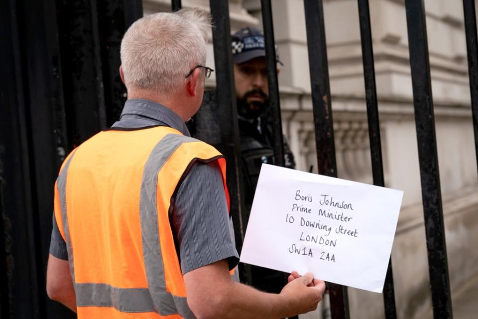 A member of Insulate Britain attempts to hand in a letter for Prime Minister Boris Johnson at 10 Downing Street (PA) (PA Wire)