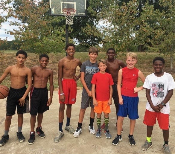 Cade Phillips, middle, grew up playing basketball games on a blacktop at Big Oak Ranch in Gadsden, Alabama.