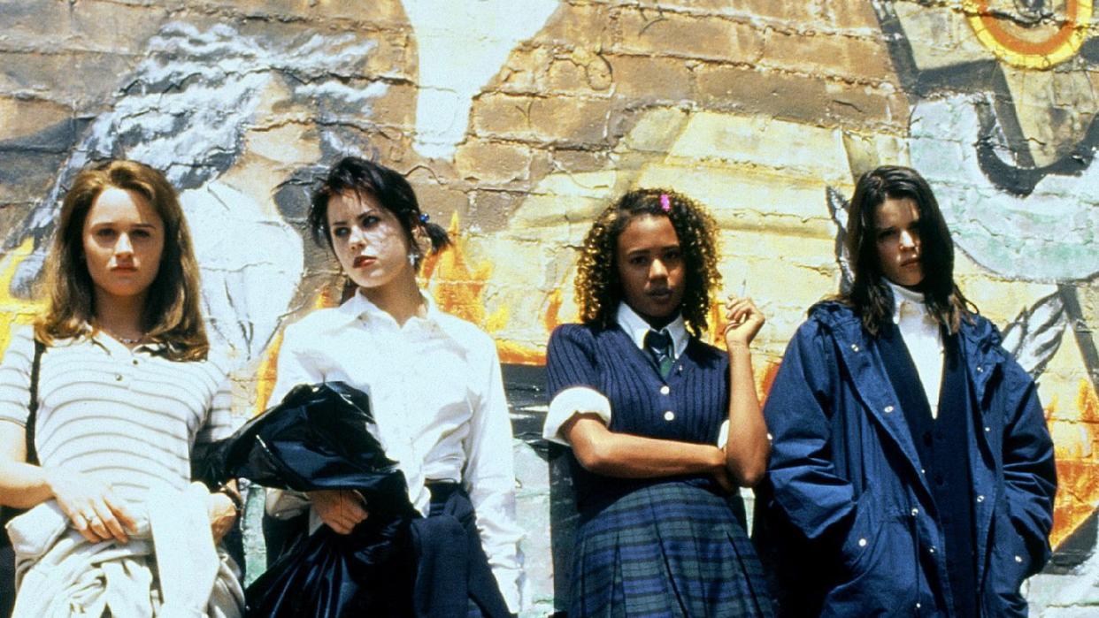 four teen witches lean against a wall in a scene from 'the craft,' a good housekeeping pick for best halloween movies