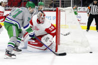 Carolina Hurricanes' Jesper Fast (71) and Detroit Red Wings goaltender Thomas Greiss (29) watch the rebounding puck during the second period of an NHL hockey game in Raleigh, N.C., Saturday, April 10, 2021. (AP Photo/Karl B DeBlaker)