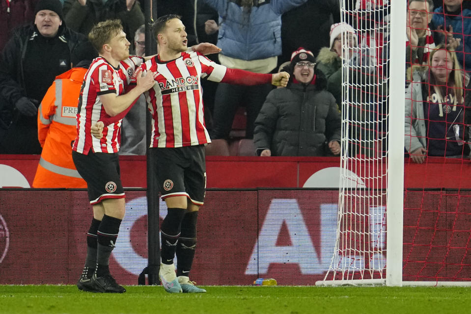 Sheffield's Billy Sharp, centre, celebrates after scoring his side's second goal during the FA Cup 4th round soccer match between Sheffield United and Wrexham at the Bramall Lane stadium in Sheffield, England, Tuesday, Feb. 7, 2023. (AP Photo/Jon Super)