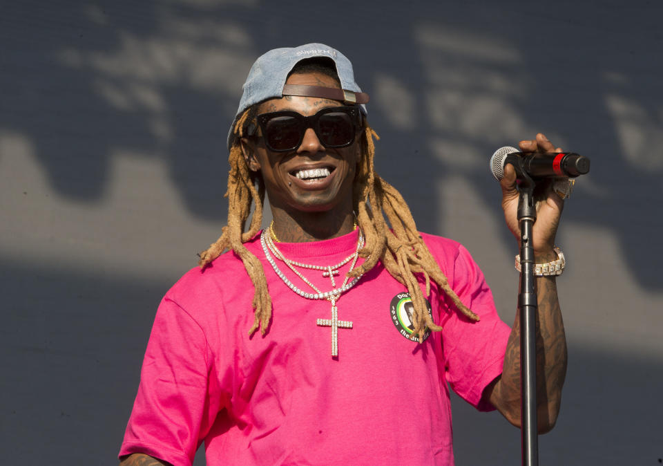 FILE - In this June 16, 2018, file photo, Lil Wayne performs on Day 3 of the 2018 Firefly Music Festival at The Woodlands in Dover, Del. Rapper Lil Wayne has been charged with possession of a firearm by a convicted felon, an offense that carries a potential sentence of up to 10 years in prison. Documents filed Tuesday, Nov. 17, 2020, in Miami federal court say the rapper, whose real name is Dwayne Michael Carter Jr., had a gun and ammunition on Dec. 23 of last year despite knowing he had the previous felony. (Photo by Owen Sweeney/Invision/AP, File)