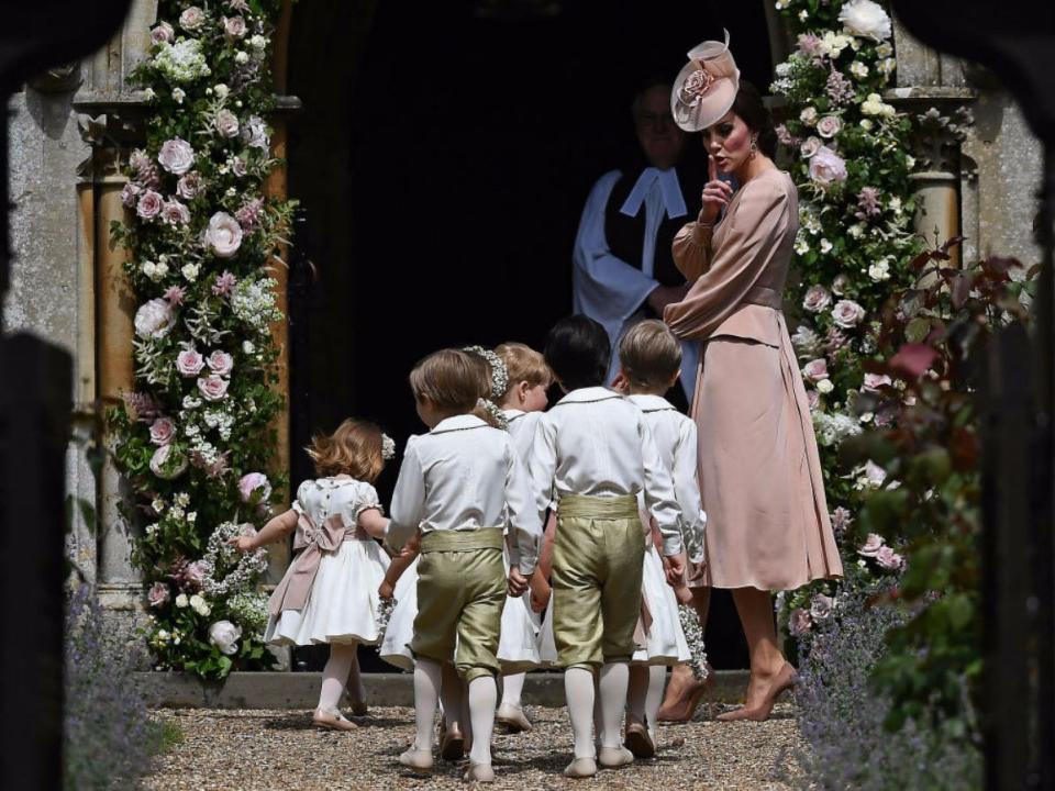 Kate Middleton shushes the pageboys and flower girls at Pippa's wedding.