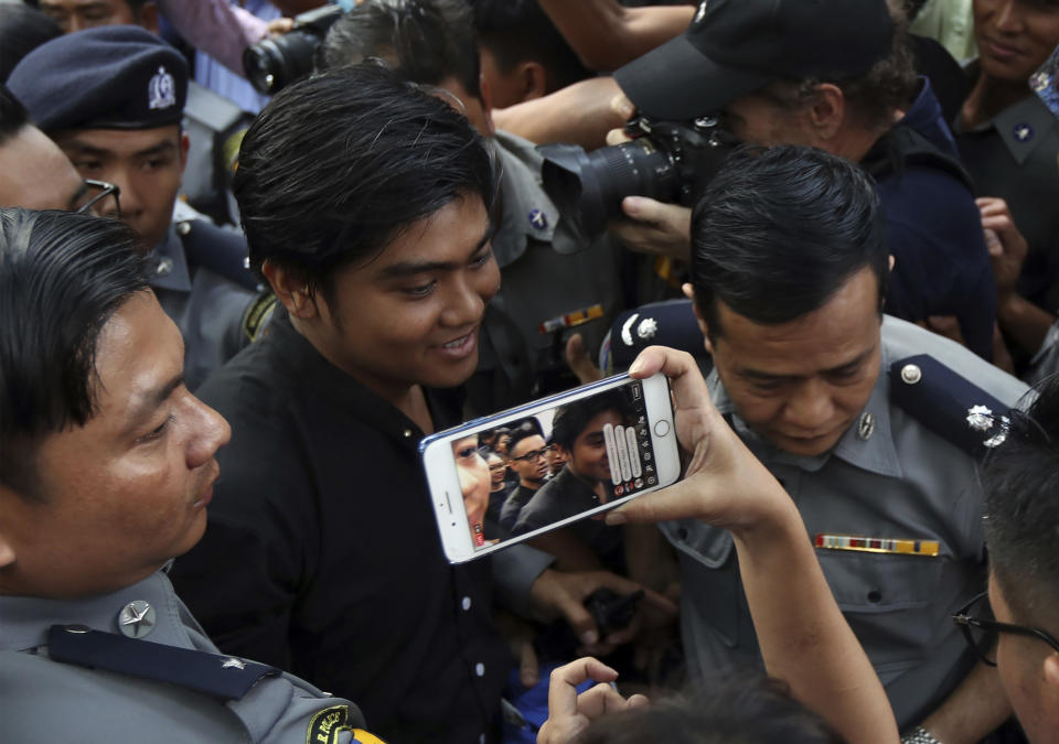 Zayar Lwin, center, member of the Student Union and a leader of Peacock Generation "Thangyat" Performance Group, is escorted at a township court for their trial Wednesday, Oct. 30, 2019, in Yangon, Myanmar. Zayar Lwin and others were charged with one year of hard labor for a satirical performance against the military earlier this year. (AP Photo/Thein Zaw)