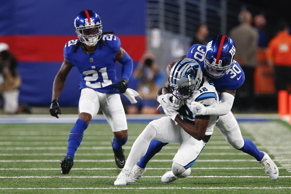 New York Giants' Darnay Holmes (30), right, tackles Carolina Panthers' Shi Smith during the second half of an NFL preseason football game, Friday, Aug. 18, 2023, in East Rutherford, N.J. (AP Photo/John Munson)