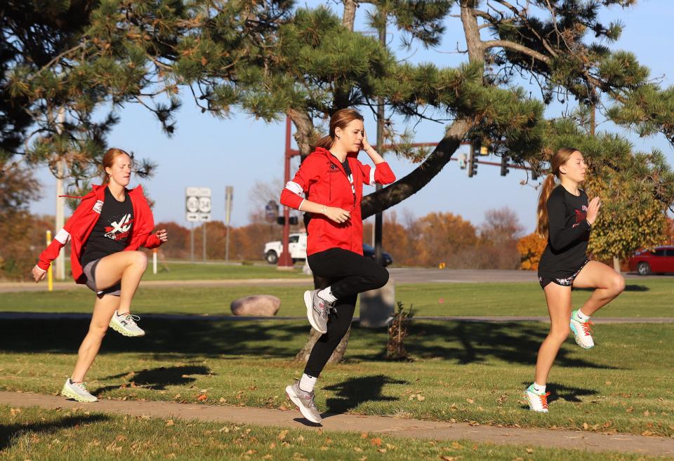 SCC women's cross country runners, from left, Cassidy Yaley, Carissa Mackey and Brooklyn Moehle warm up during practice Wednesday on the campus in West Burlington.