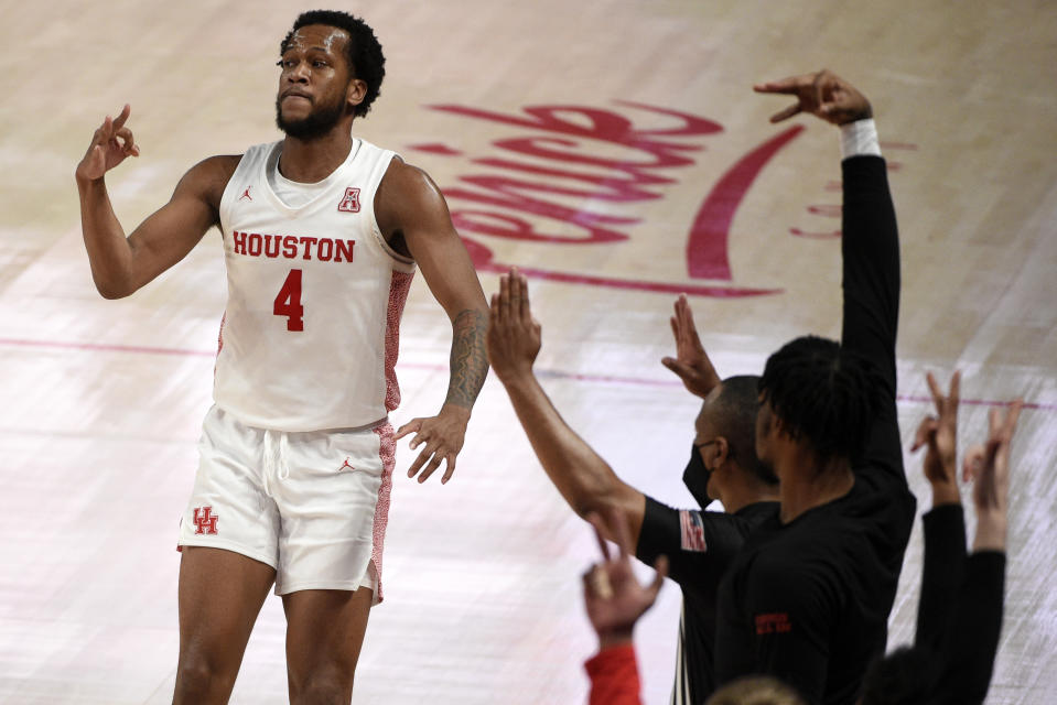 Houston forward Justin Gorham (4) reacts assert making a 3-point basket during the second half of an NCAA college basketball game against Cincinnati, Sunday, Feb. 21, 2021, in Houston. (AP Photo/Eric Christian Smith)