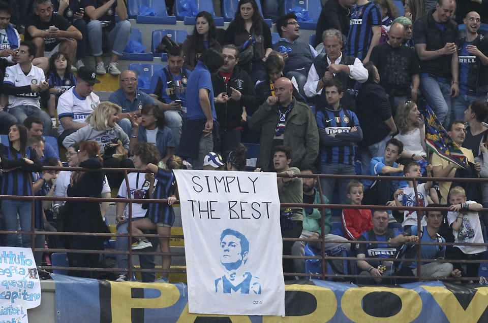 Fans show banners prior to the start of the Serie A soccer match between Inter Milan and Lazio at the San Siro stadium in Milan, Italy, Saturday, May 10, 2014. (AP Photo/Antonio Calanni)