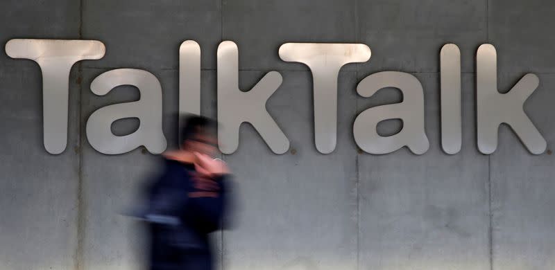 FILE PHOTO: A man walks past a company logo outside a TalkTalk building in London, Britain