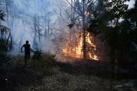 Flames burn a forrest during a wildfire in Adames area, in northern Athens, Greece, Tuesday, Aug. 3, 2021.Thousands of people fled their homes north of Athens on Tuesday as a wildfire broke out of the forest and reached residential areas. The hurried evacuations took place just as Greece grappled with its worst heat wave in decades. (AP Photo/Michael Varaklas)