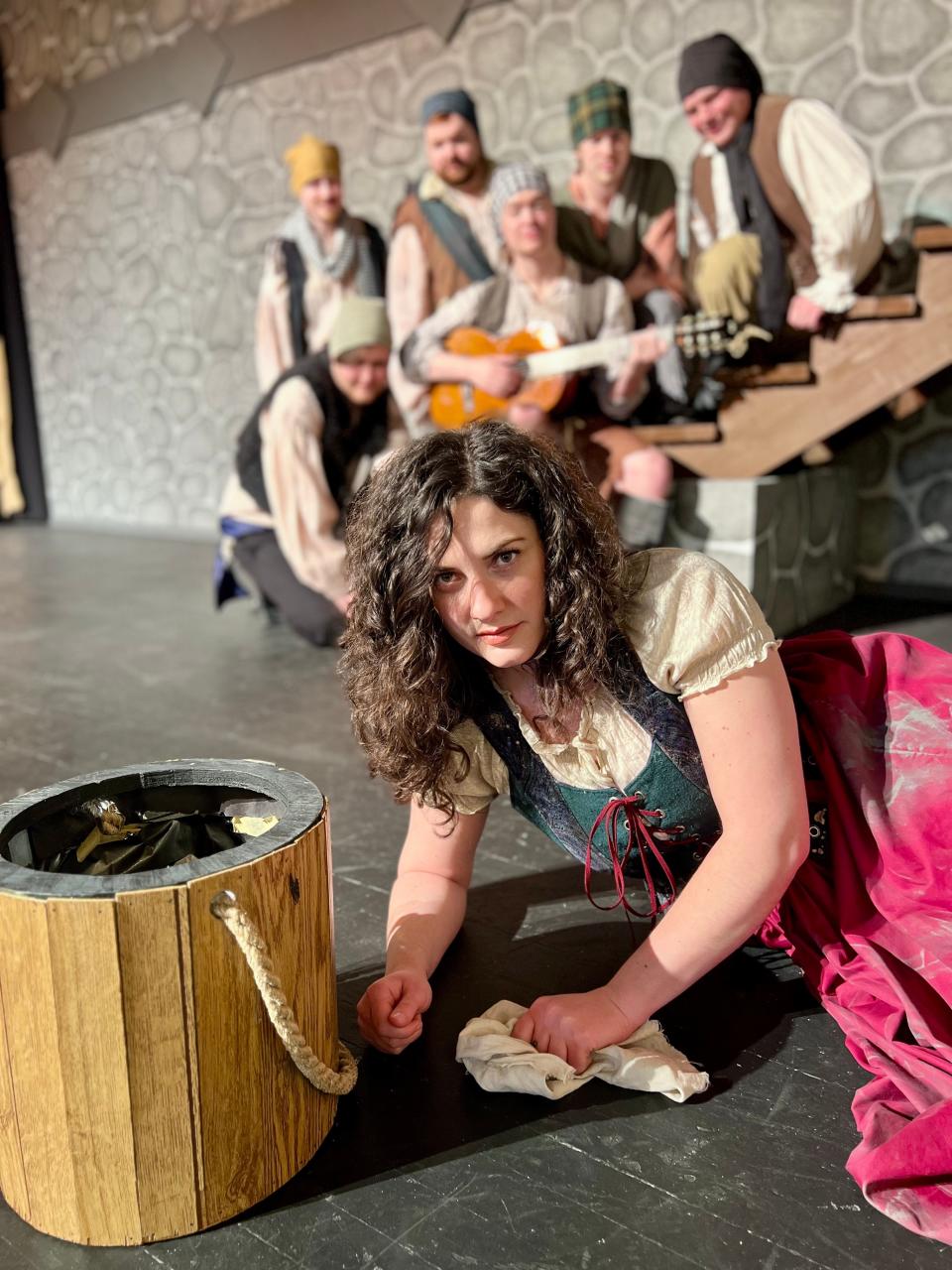 Aldonza (Hannah Starcher) is serenaded by Muleteers (L to R) Billy Saunders, Mikey Schrum, Alex Hazen, Scott Thompson, Simon Burkhammer (kneeling) and Aaron Shanor (with guitar) in Center Theatre Players' "Man of La Mancha."