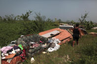 <p>Cynthia Calderon walks past some furniture and other belongings she could salvage, after the island was hit by Hurricane Maria in September, in Toa Alta, Puerto Rico, Oct. 19, 2017. (Photo: Alvin Baez/Reuters) </p>