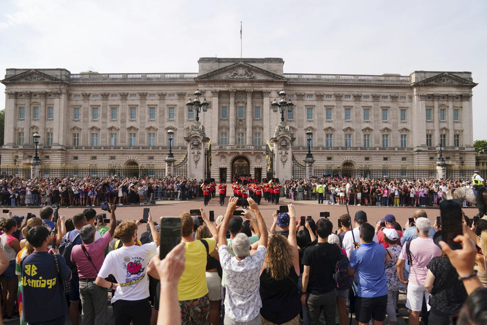 Crowds watch the Changing of the Guard ceremony at Buckingham Palace in London, on the first anniversary of Queen Elizabeth II's death, Friday Sept. 8, 2023. (Victoria Jones/PA via AP)