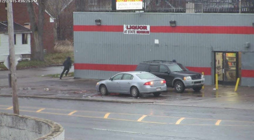 FBI pole cameras capture a Detroit gang member fleeing the scene after opening fire on a vehicle outside a market on the city's east side on Dec. 1, 2015. A rival gang member and 13-year-old girl inside the car were killed. Two children sitting on the roof of the car were injured.