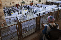 Ultra-Orthodox Jews pray in divided sections which allow a maximum of twenty worshipers in line with government measures to help stop the spread of the coronavirus, at the Western Wall, the holiest site where Jews can pray, in Jerusalem's Old City, Thursday, July 16, 2020. (AP Photo/Oded Balilty)