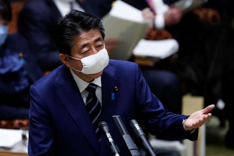 Japan's Prime Minister Shinzo Abe wears a protective face mask as he attends an upper house parliamentary session